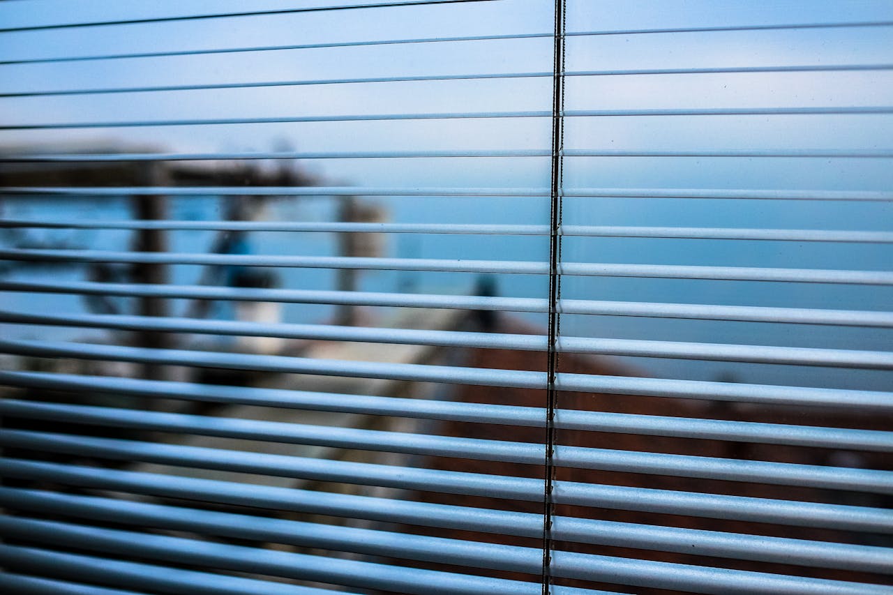 Crafting Captivating Headlines: Your awesome post title goes here Blurred outdoor scene visible through modern window blinds, creating a tranquil ambiance.